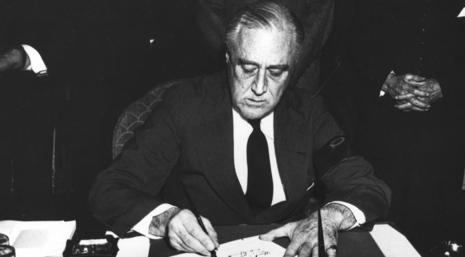 Franklin Roosevelt signing the Declaration of War