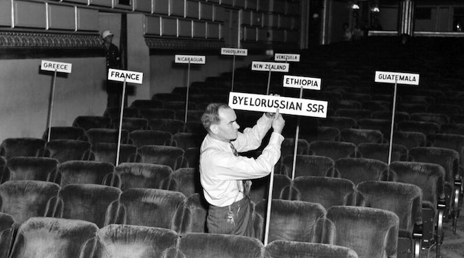 A man sets out signs at the San Francisco Conference